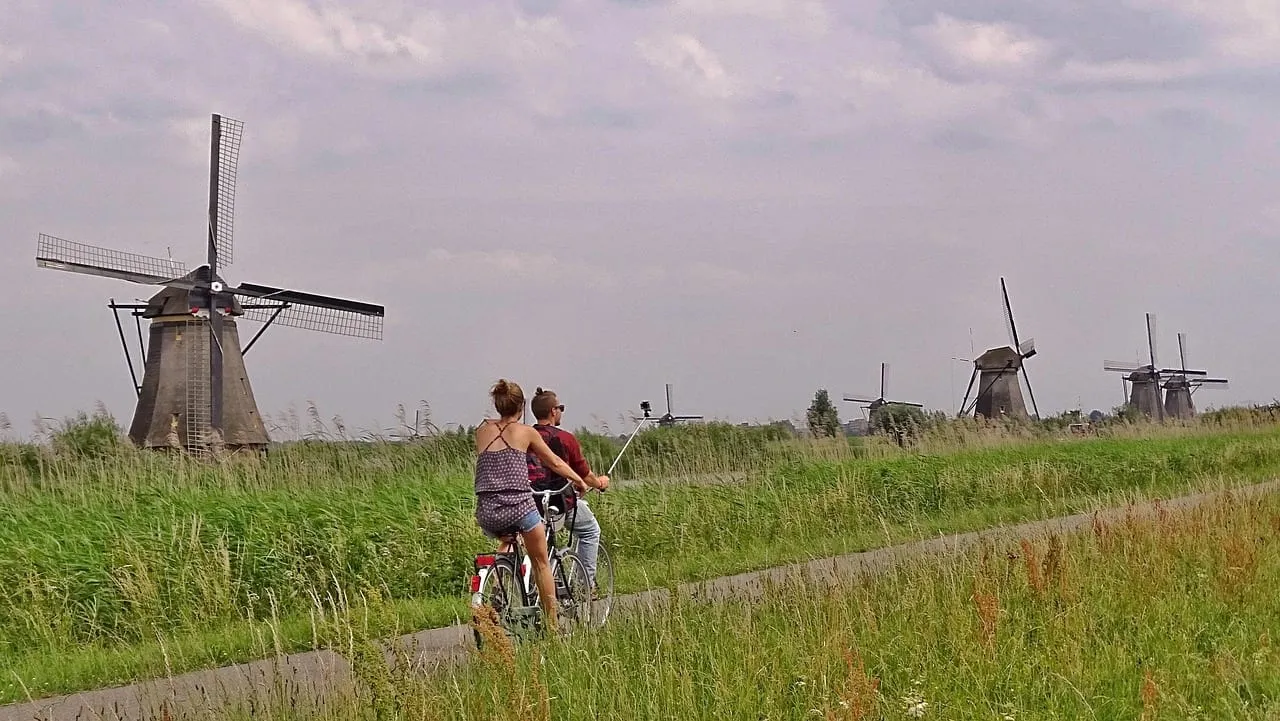 Ciclistas en el camino entre los molinos de viento